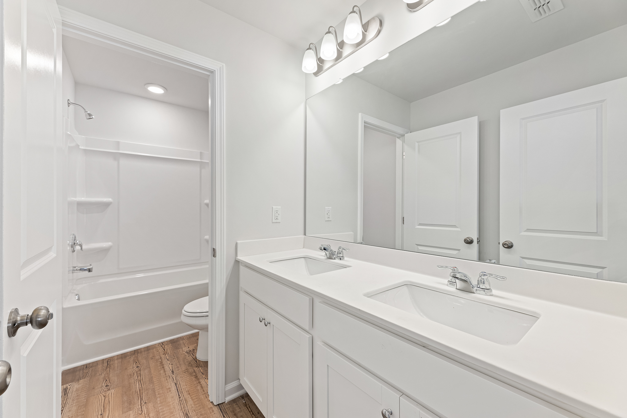 A bathroom with a tub sink and toilet.