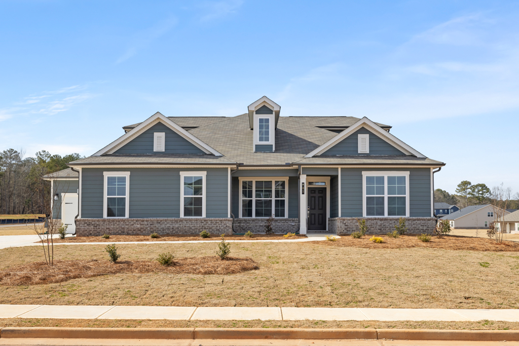 A house with a gravel yard.