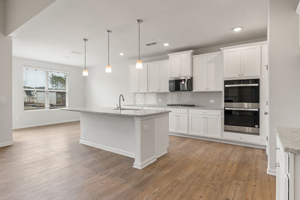 A kitchen with white cabinets.