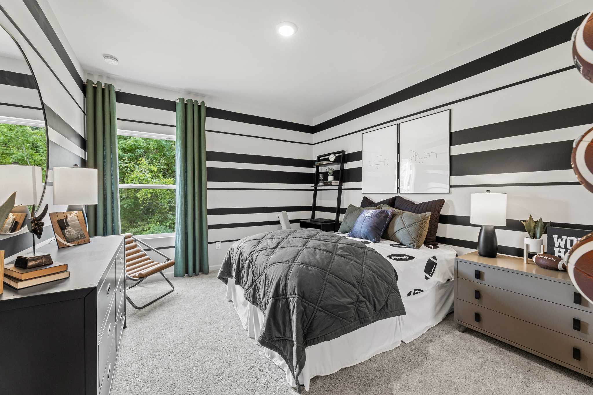 A bedroom with a bed and a desk.