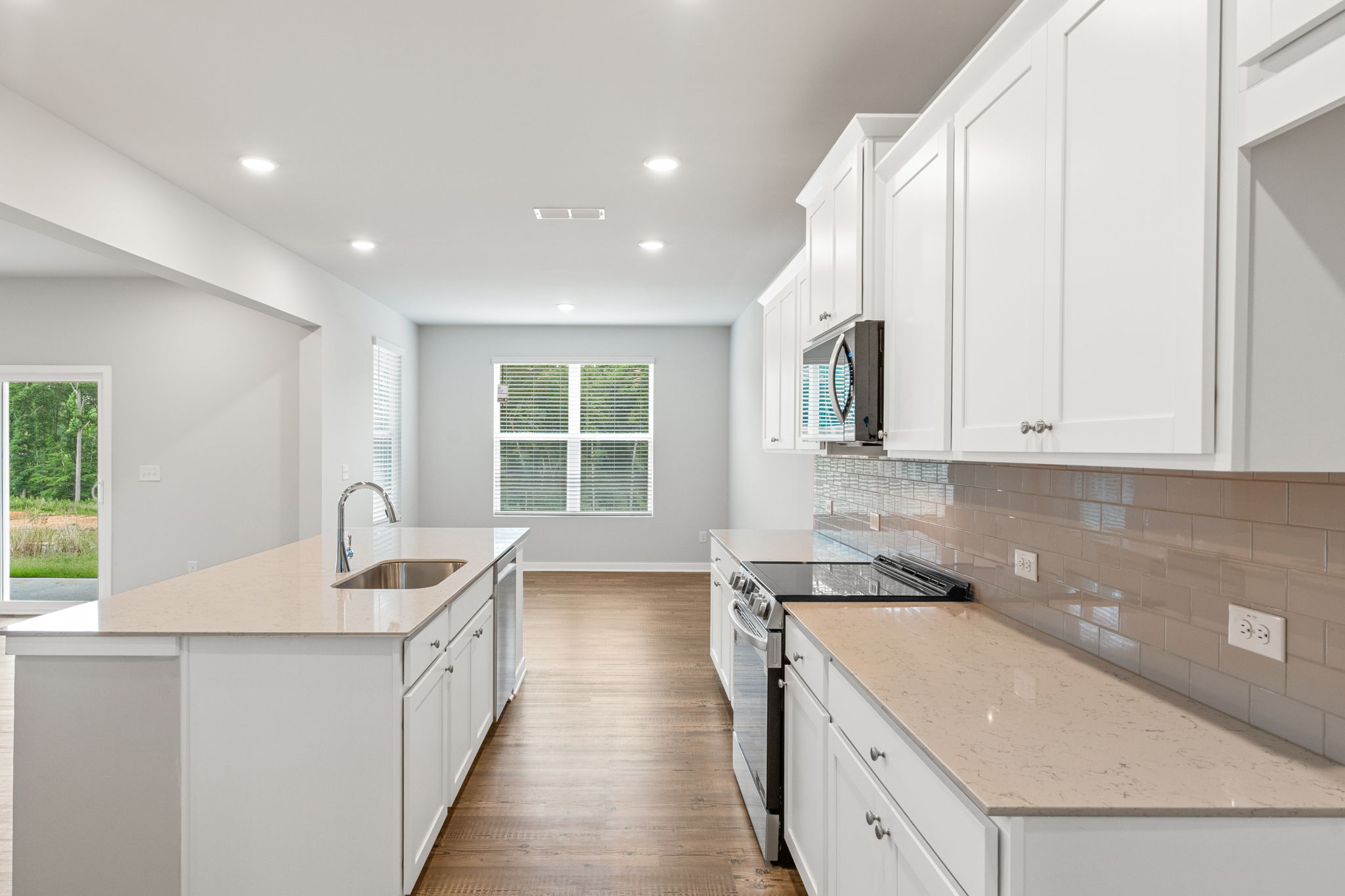 A kitchen with white cabinets.