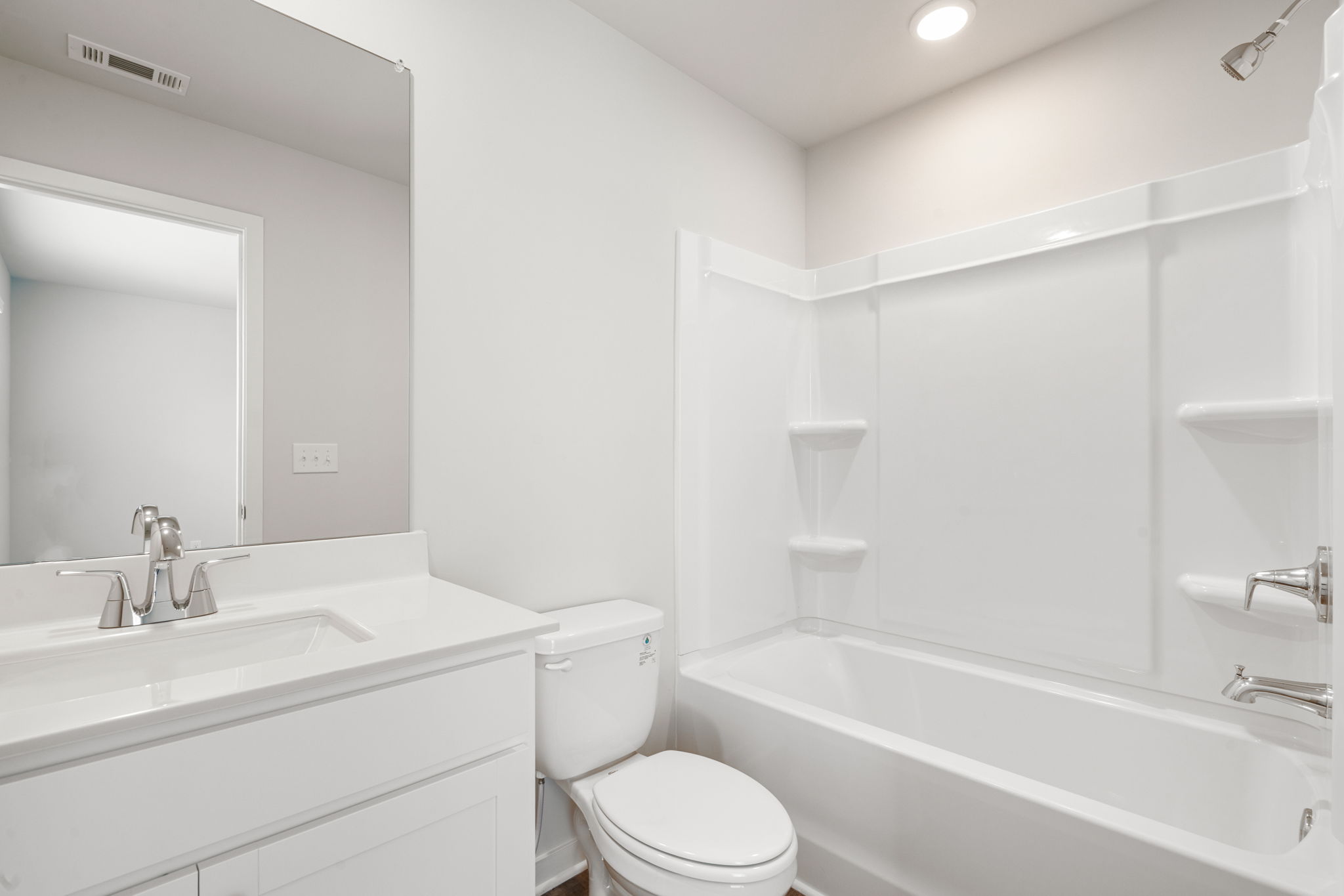 A bathroom with a tub toilet and sink.