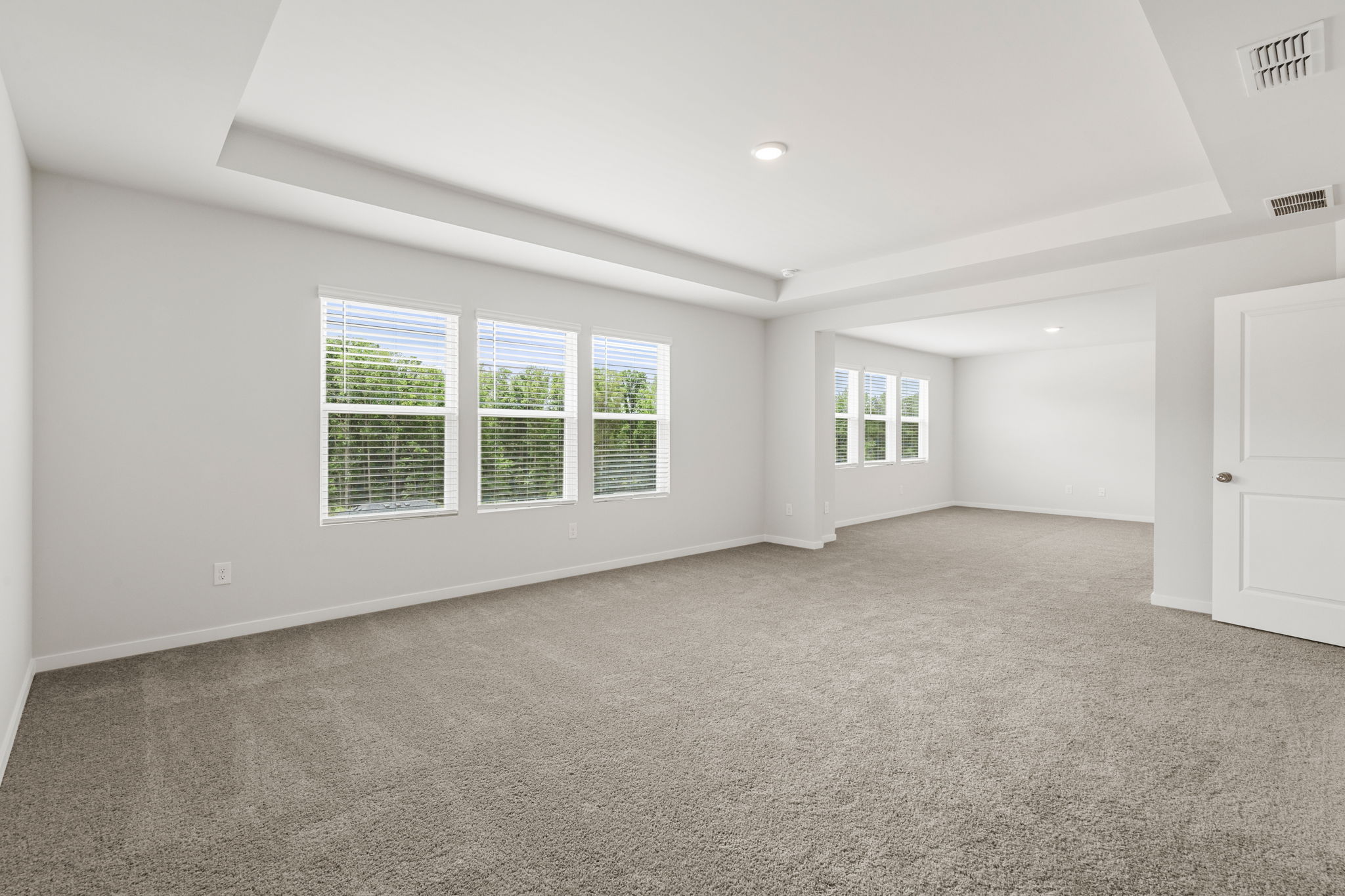 A room with white walls and windows.