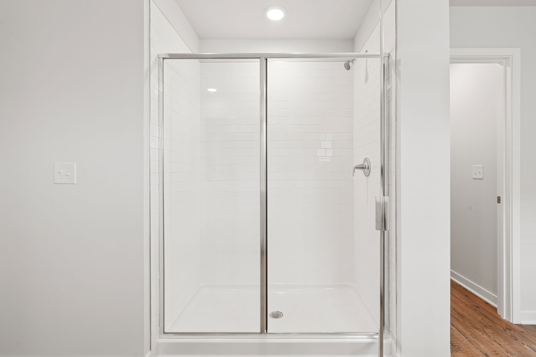 A shower with glass doors.