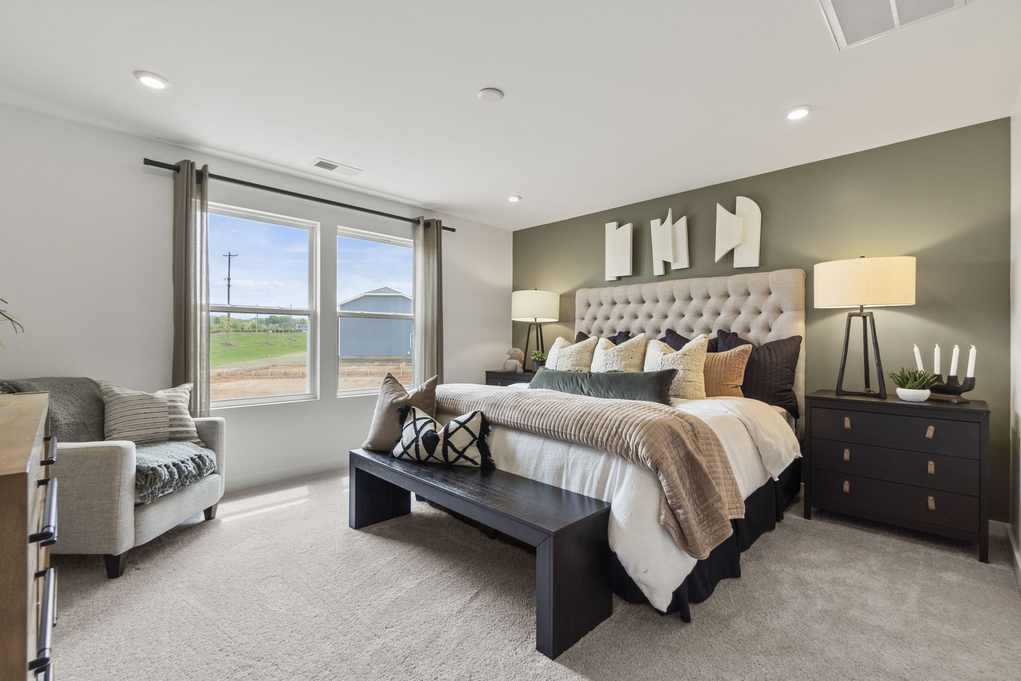 A bedroom with a large window.