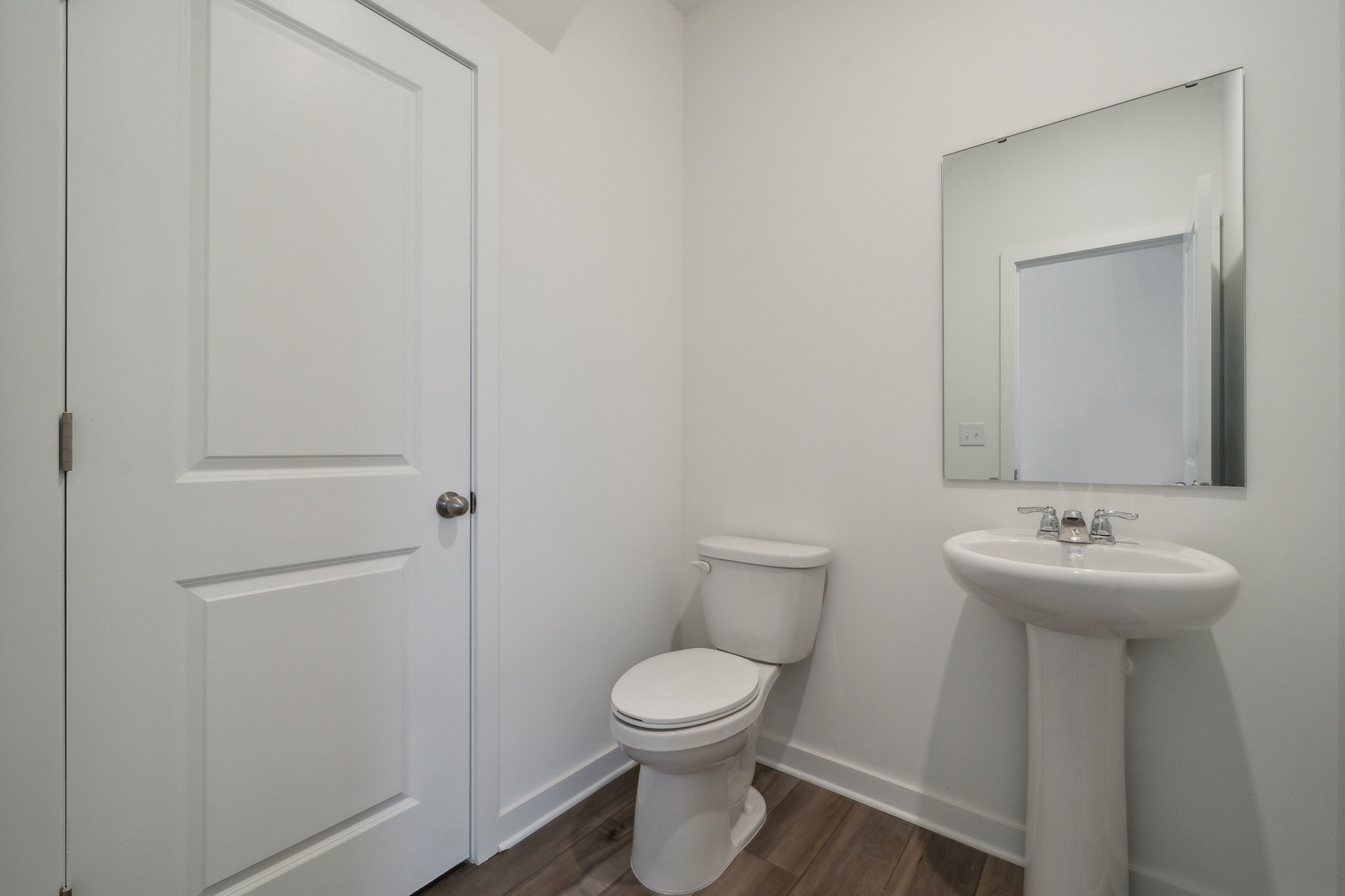 A bathroom with a toilet and sink.
