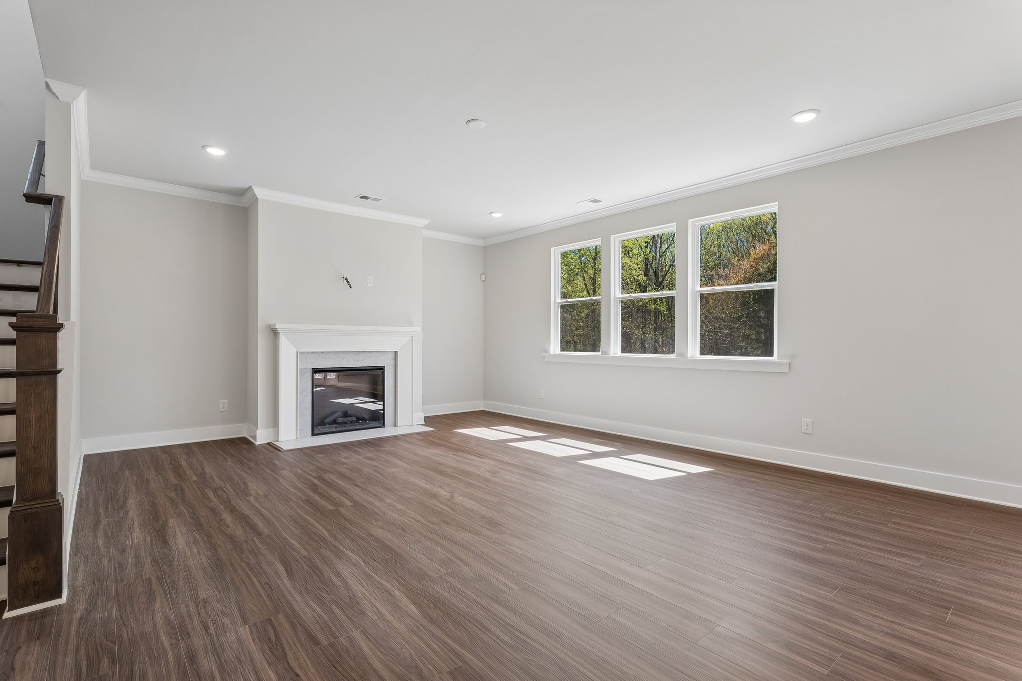 A room with a fireplace and wood floors.