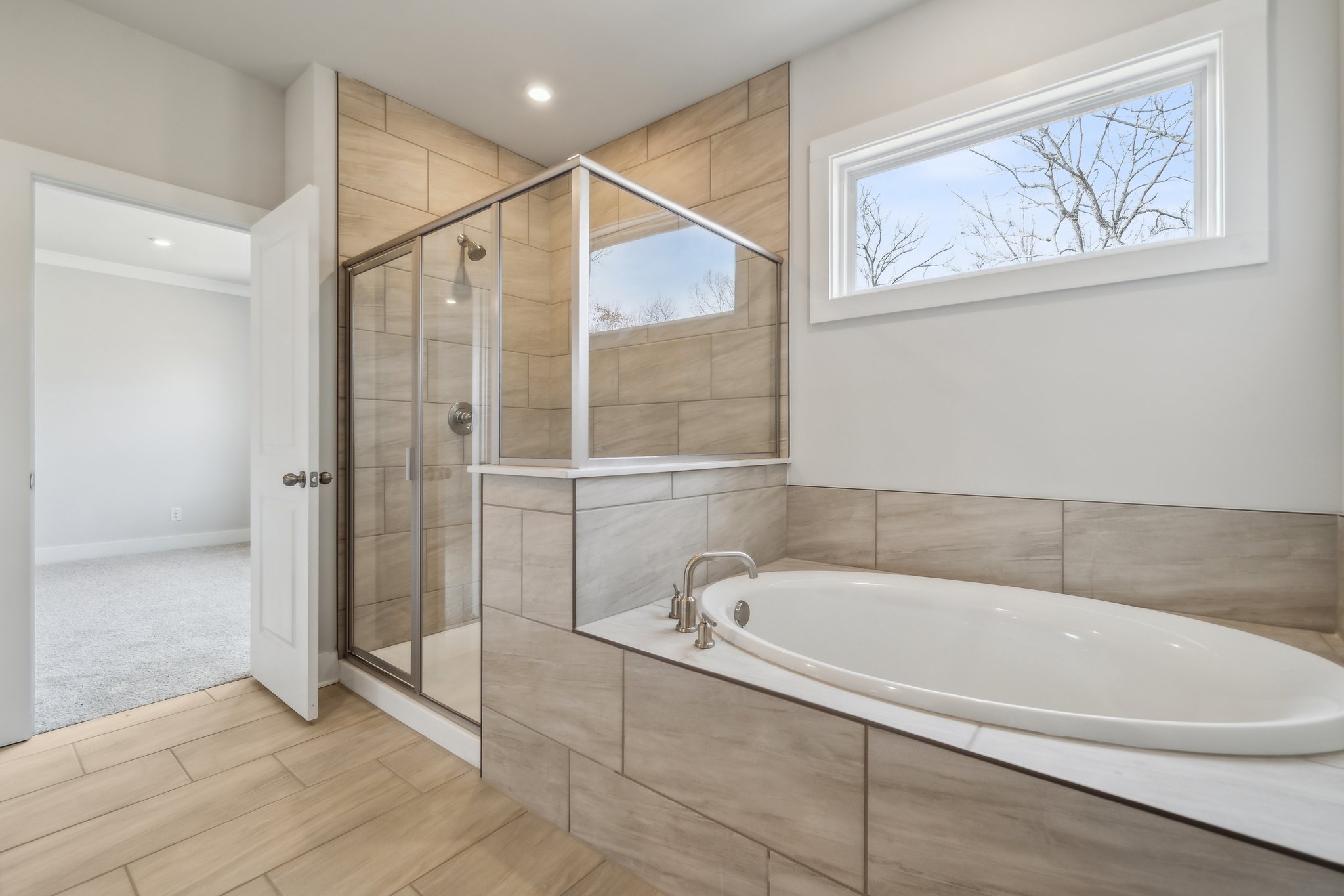 A bathroom with a tub and shower.