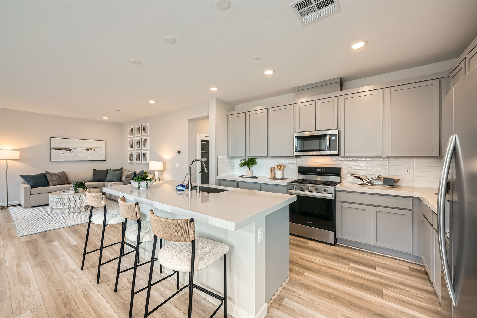 A kitchen with a bar and a table.