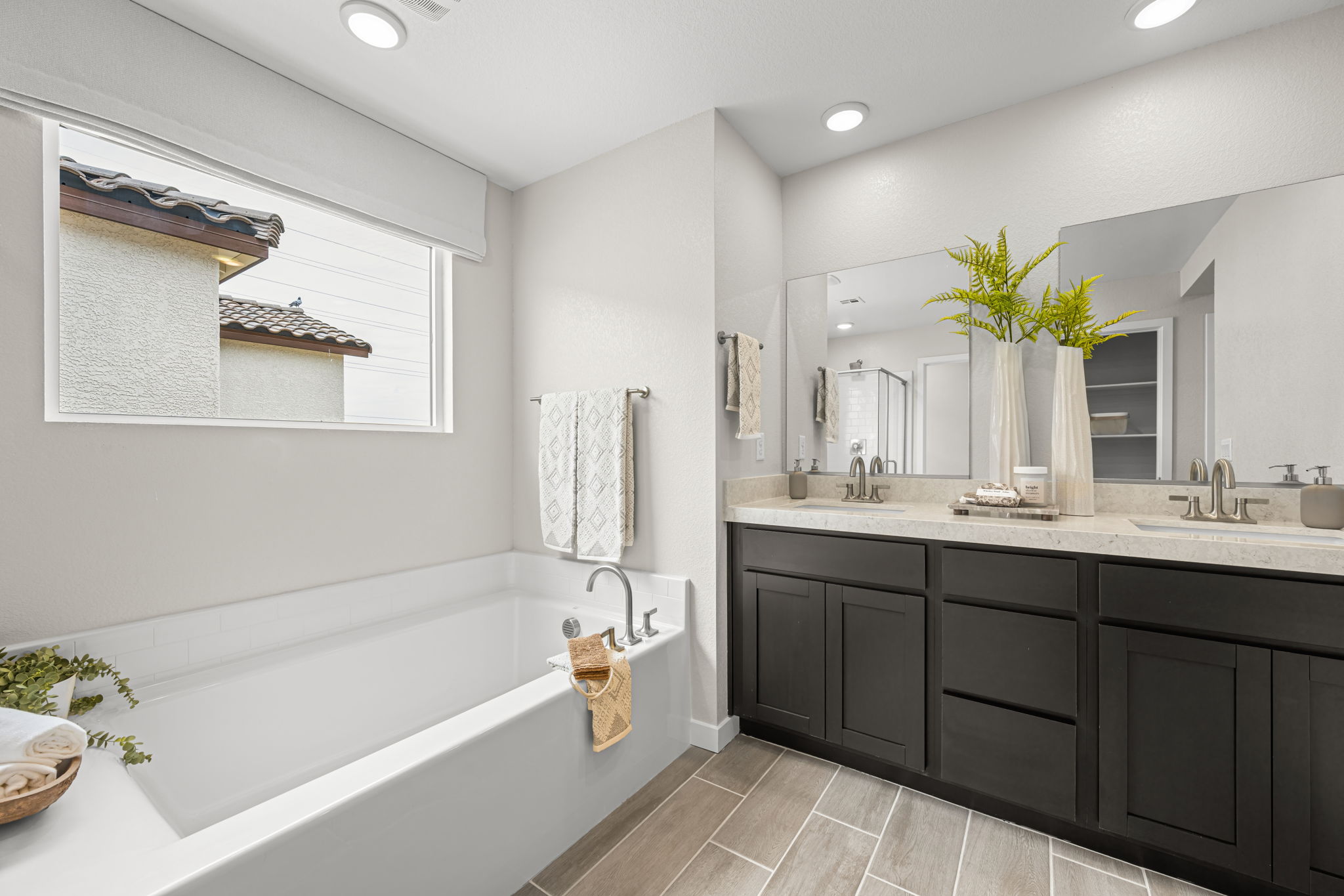 A bathroom with a tub sink and a bathtub.