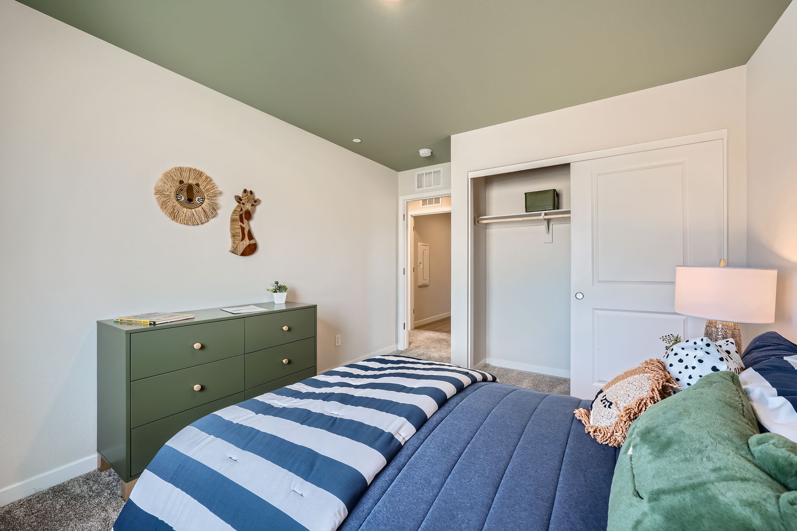 A bedroom with a bed and dresser.