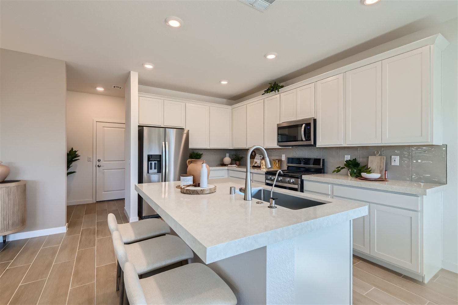 A kitchen with white cabinets.