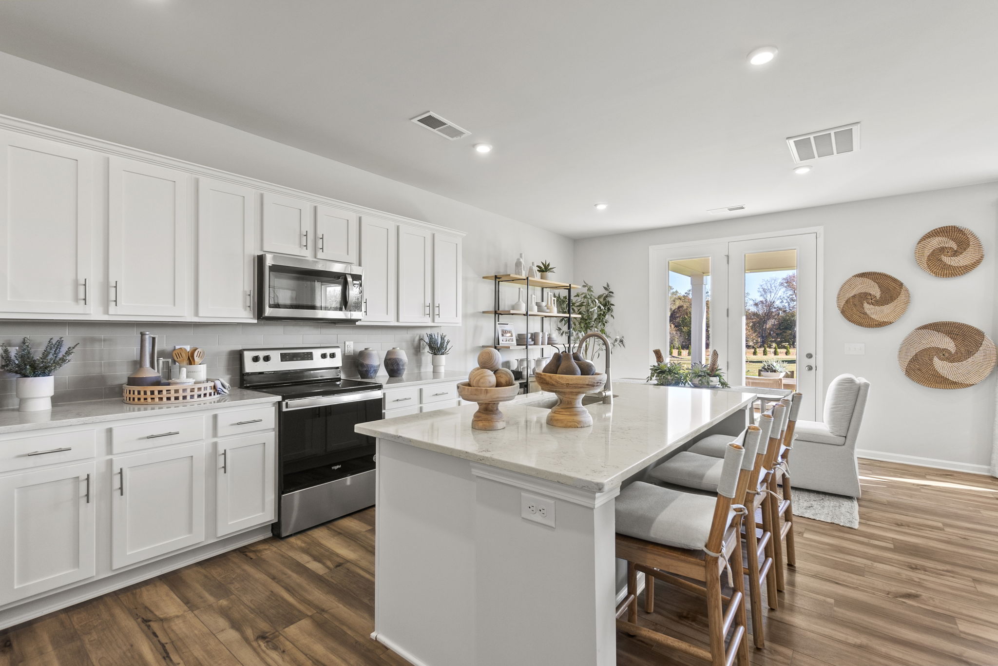 A kitchen with white cabinets.
