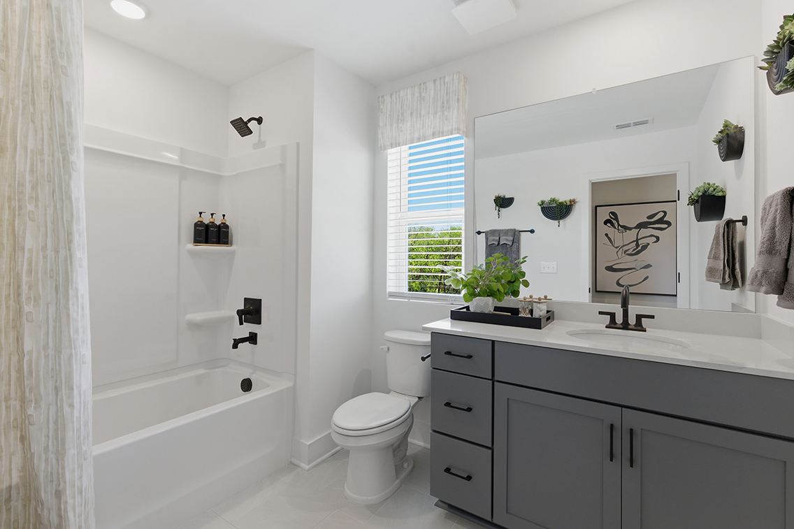 A bathroom with a tub toilet and sink.