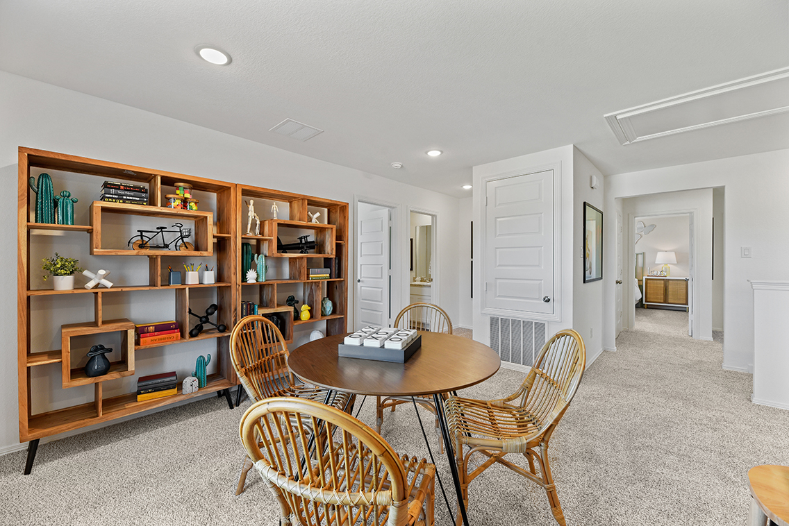 A room with a table and chairs.