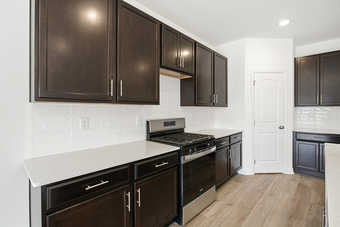 A kitchen with black cabinets.