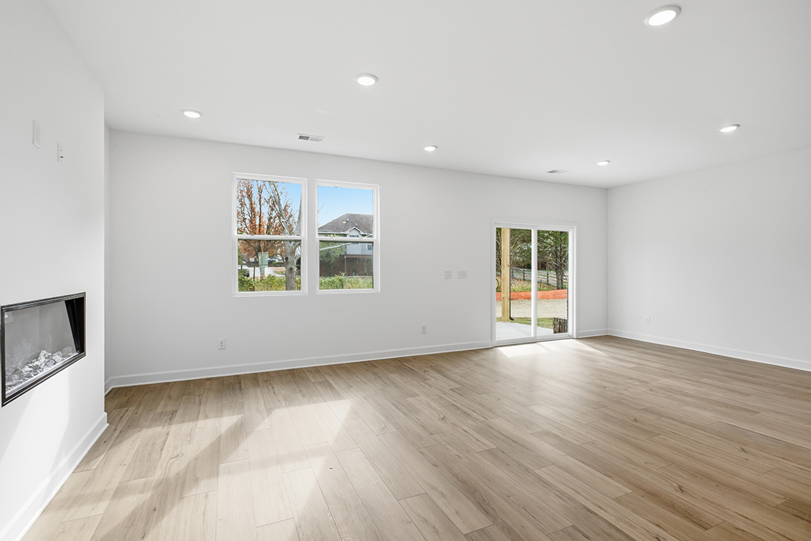 A room with a wood floor and windows.