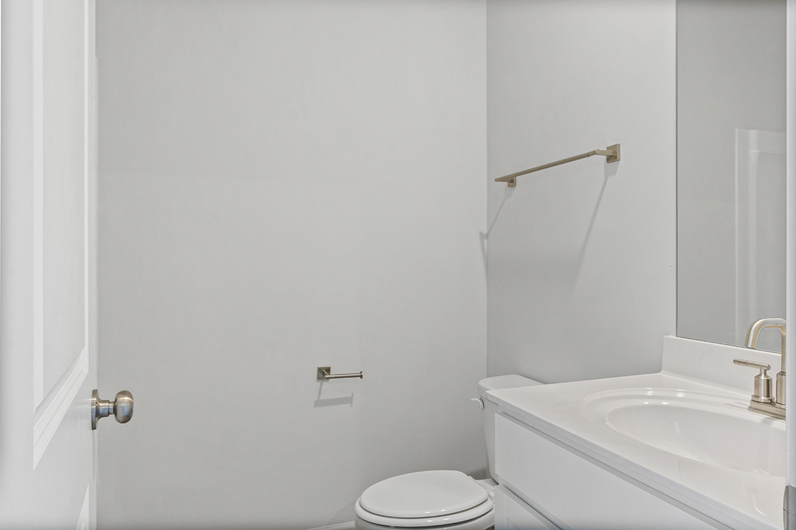 A bathroom with a toilet and sink.