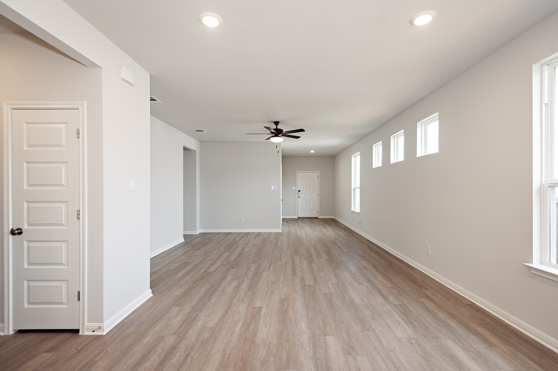 A room with white walls and a wood floor.