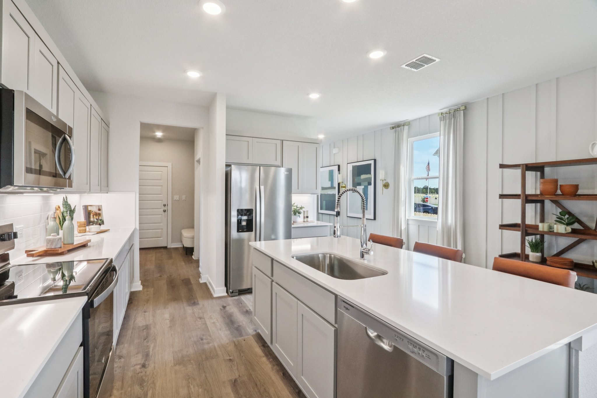 A kitchen with white cabinets.