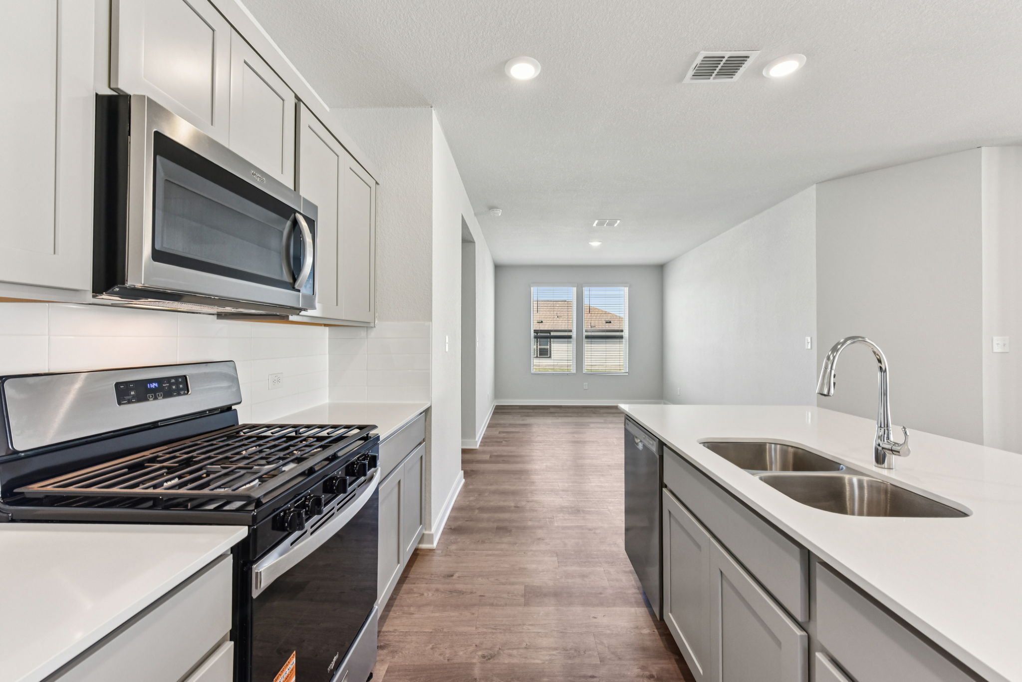 A kitchen with white cabinets.