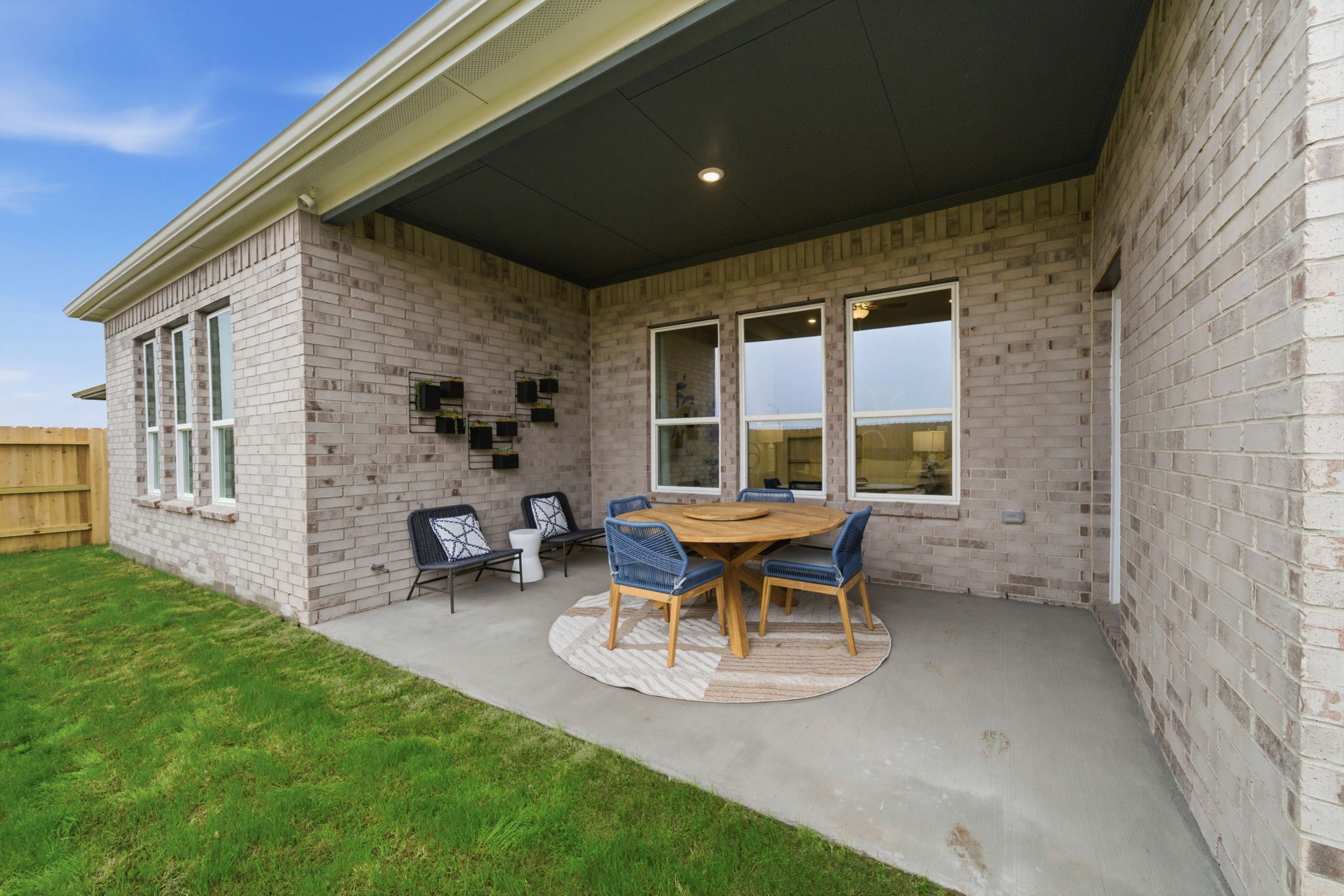 A patio with a table and chairs.