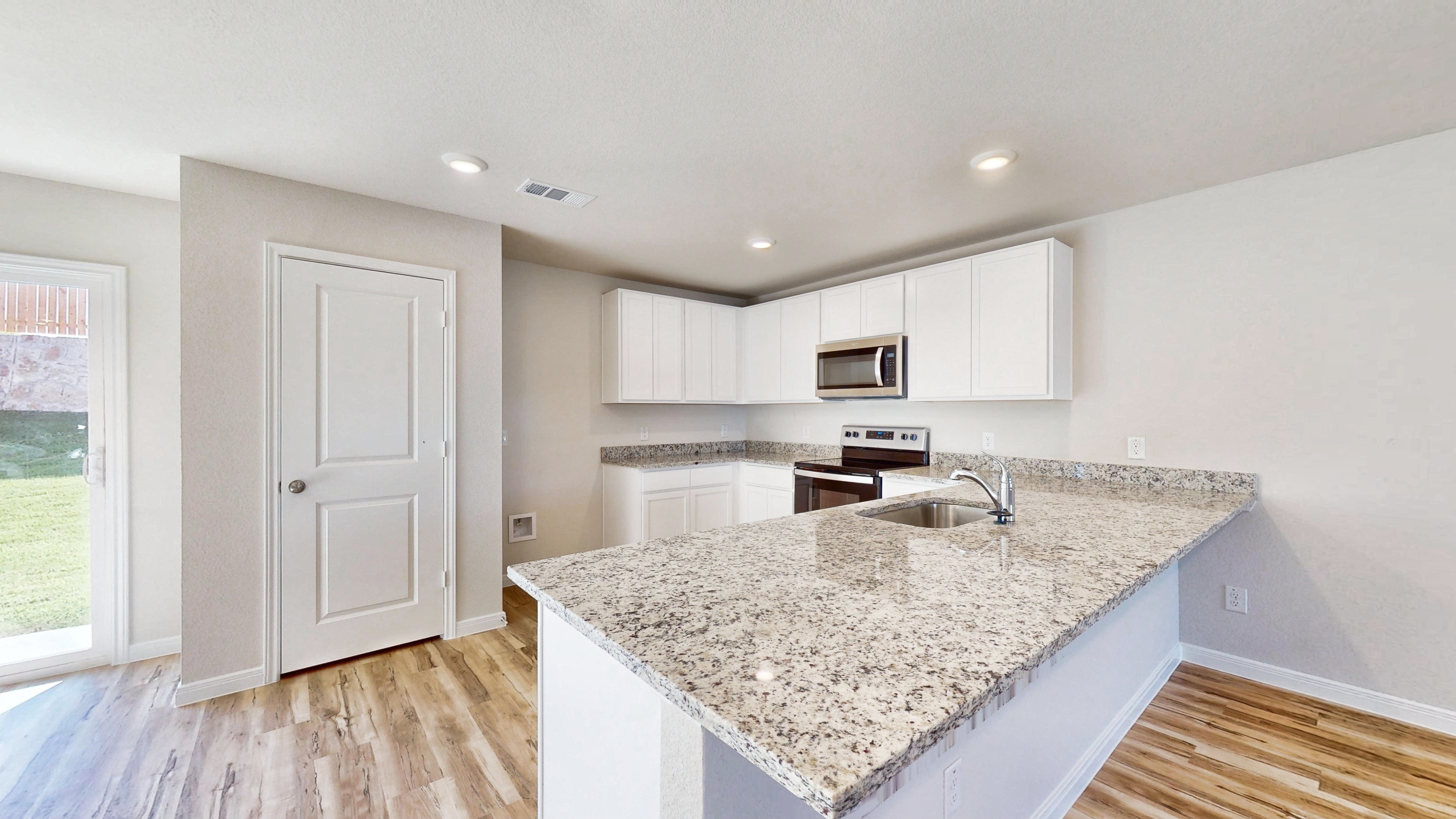 A kitchen with marble counters.