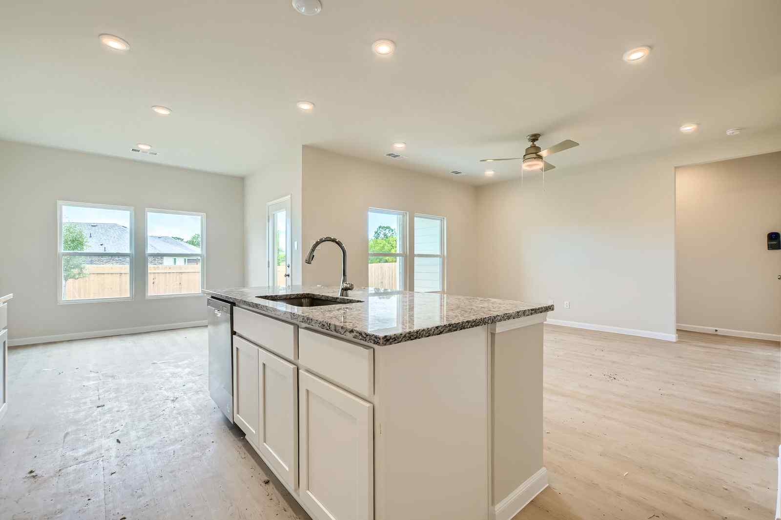A kitchen with a marble island.