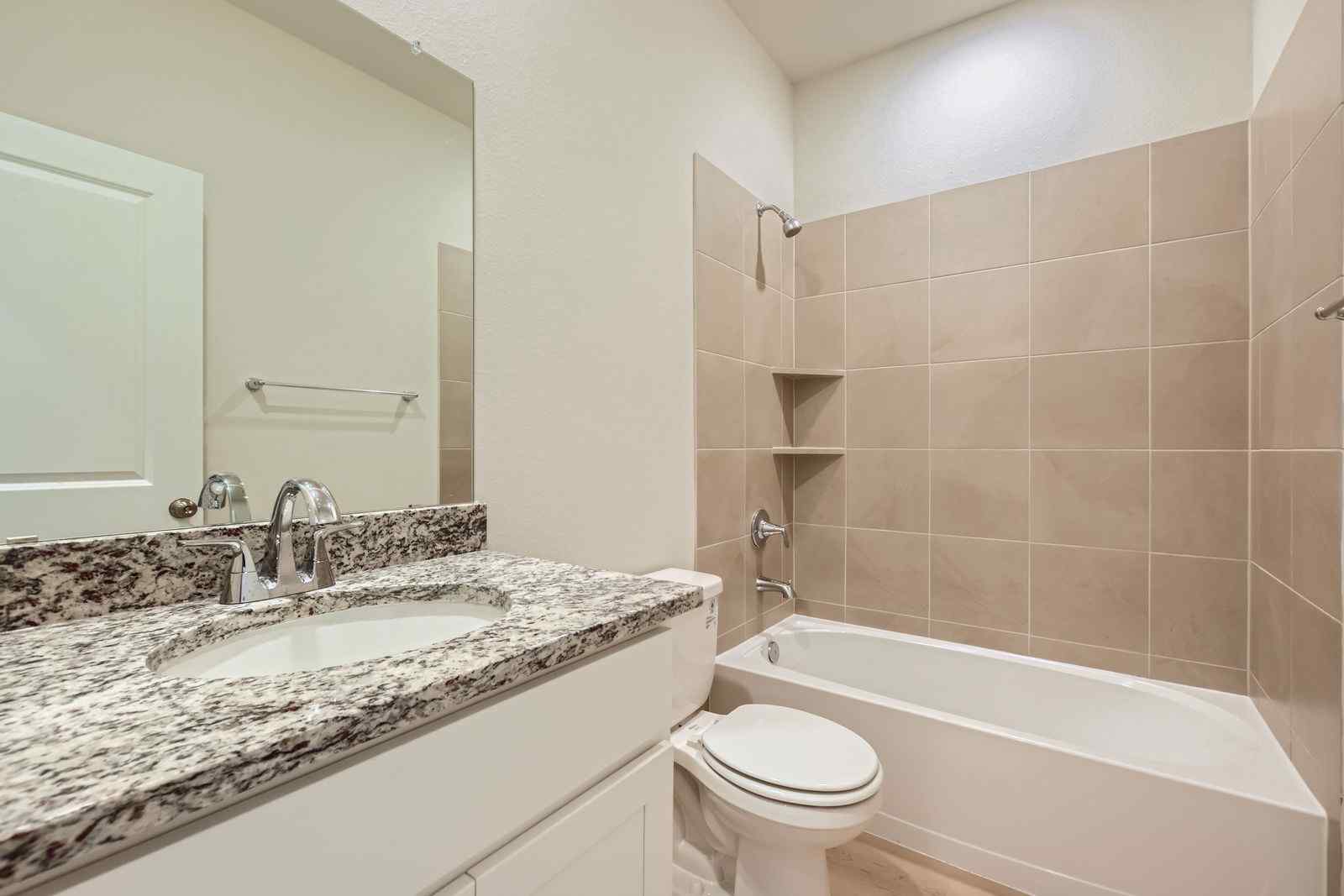 A bathroom with a tub sink and toilet.