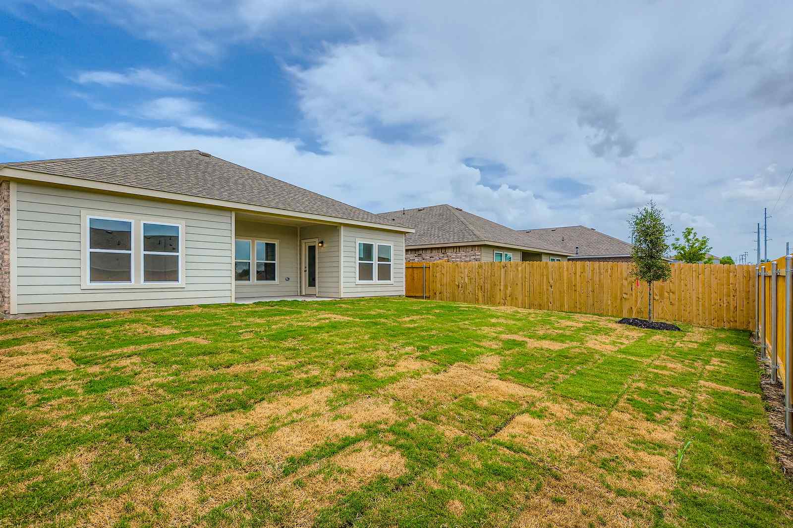 A house with a fence and grass.