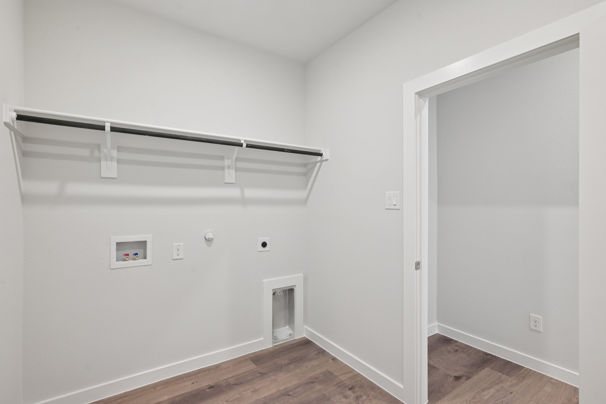 A white room with a white door.