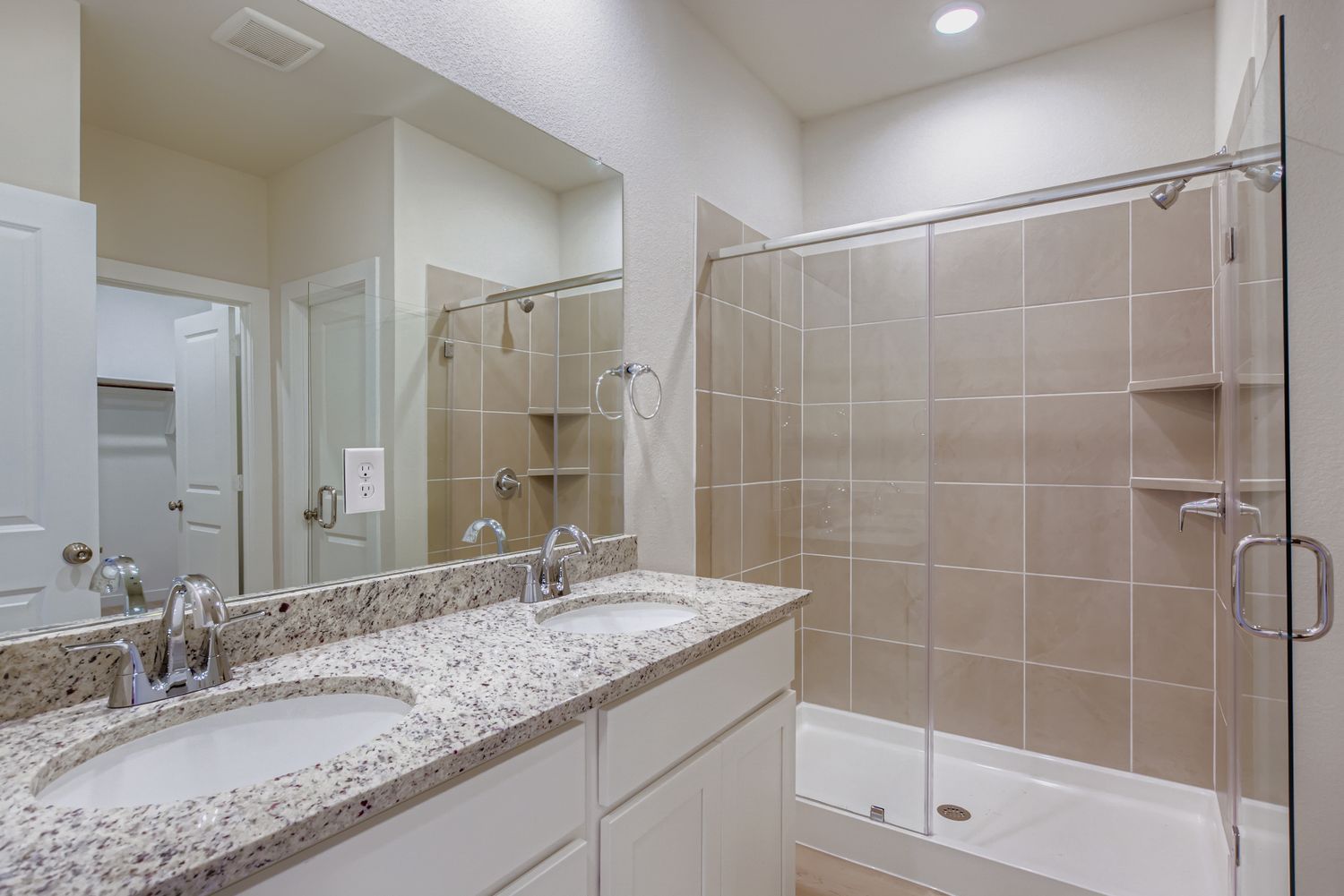 A bathroom with a large mirror.