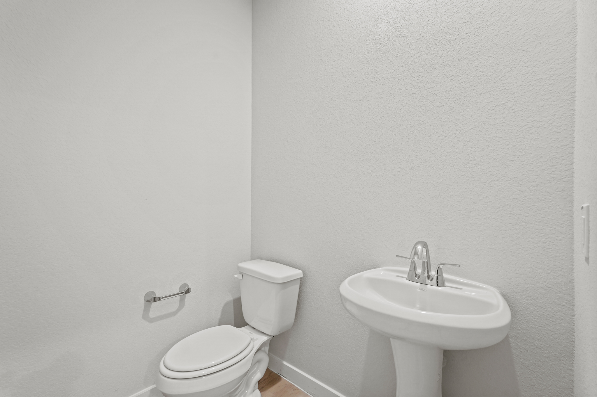 A bathroom with a toilet and sink.