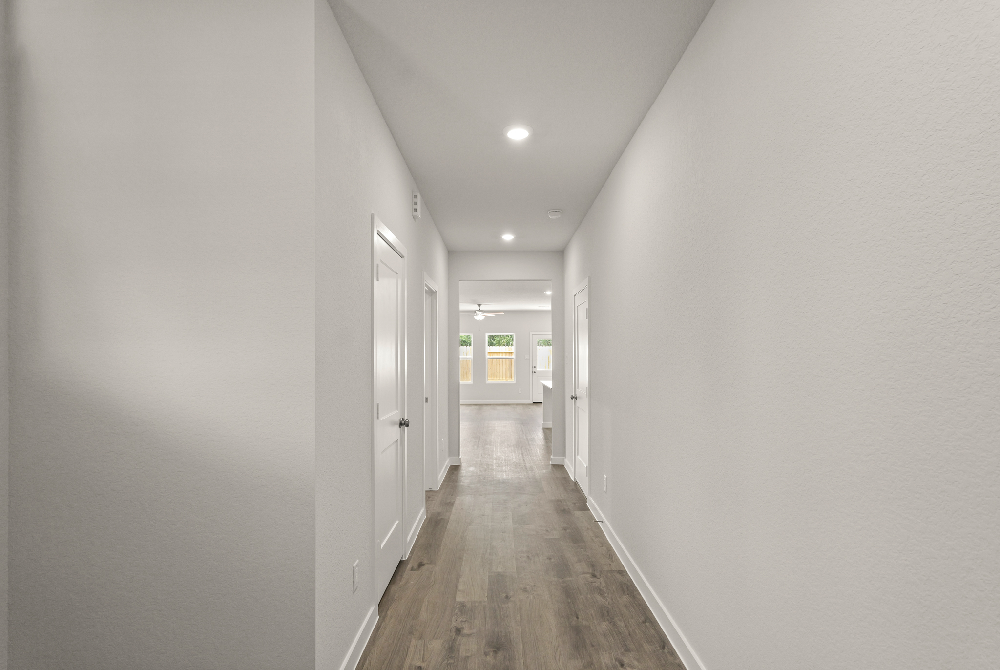 A hallway with white doors.