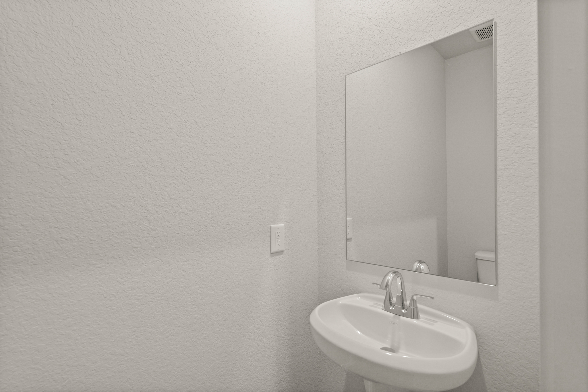 A bathroom with a large mirror.