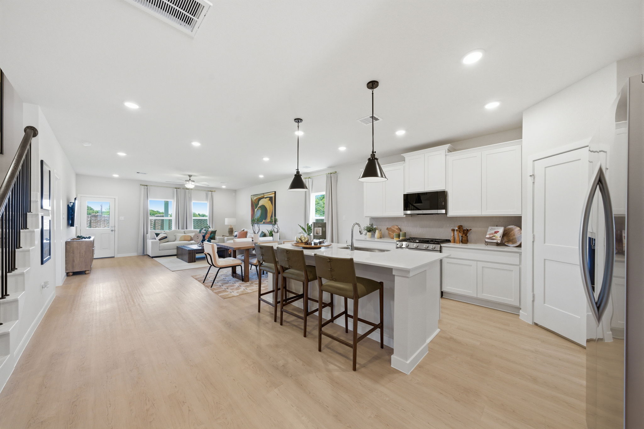A kitchen with white cabinets.