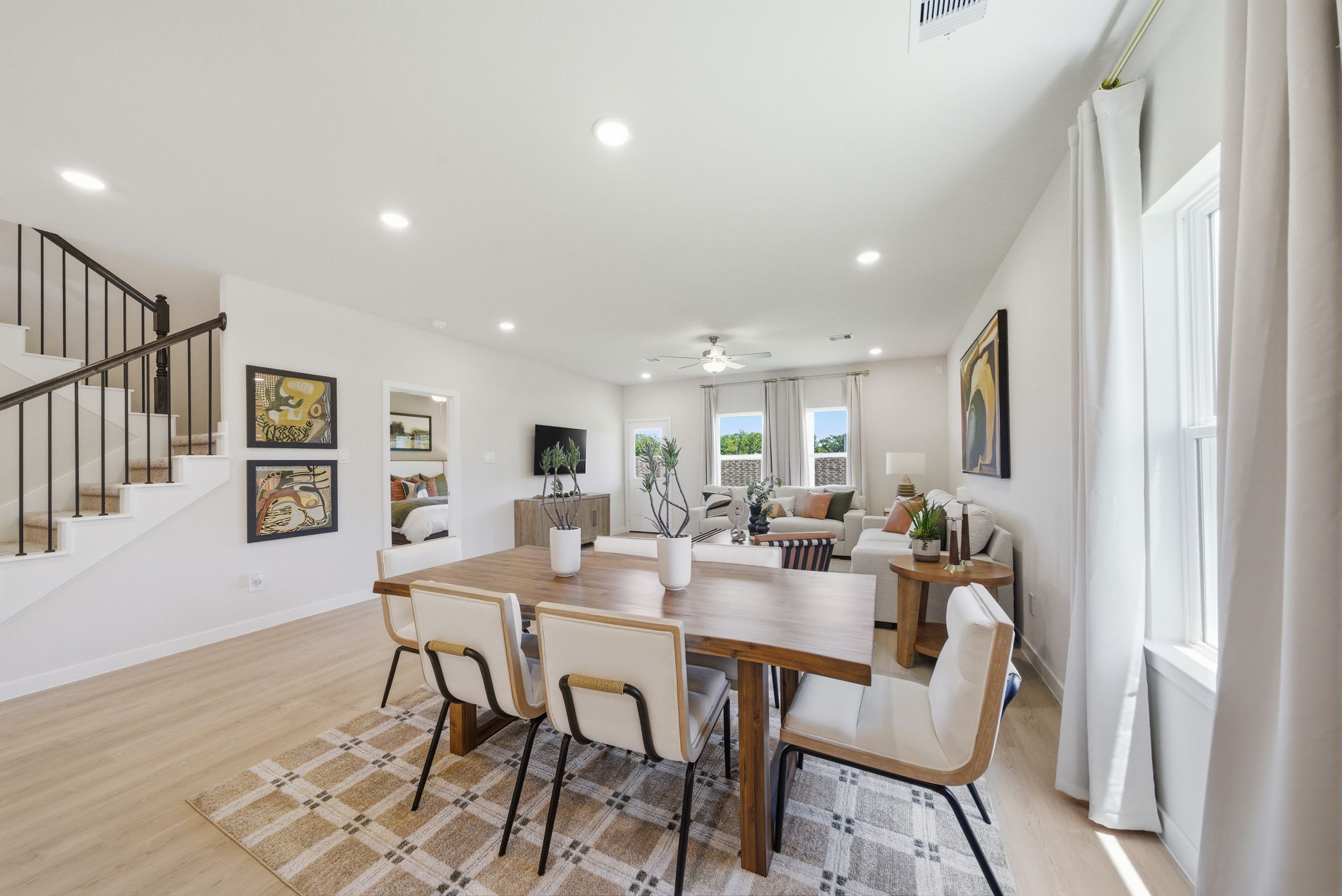A dining room with a table and chairs.