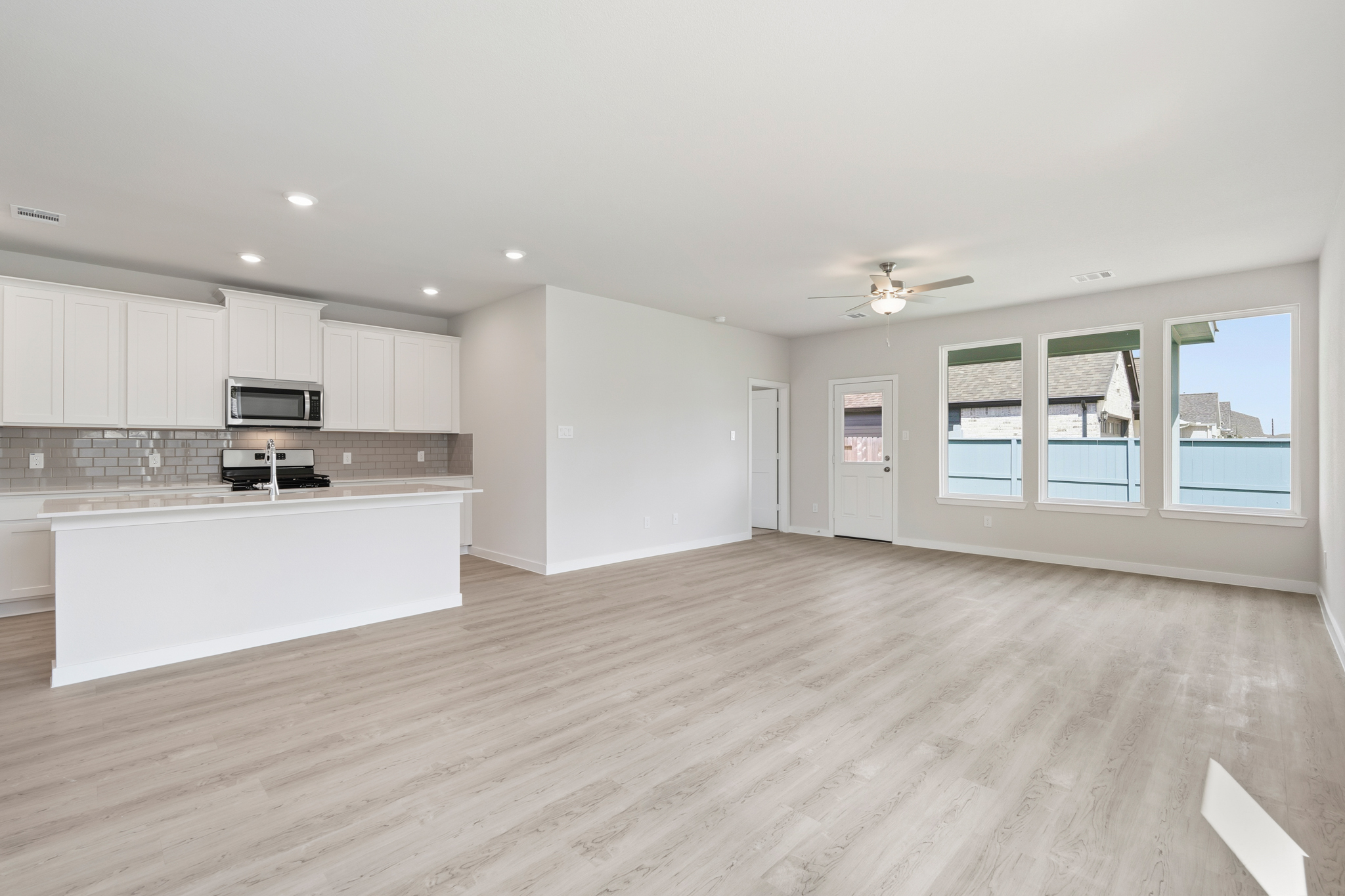 A large kitchen with white cabinets.