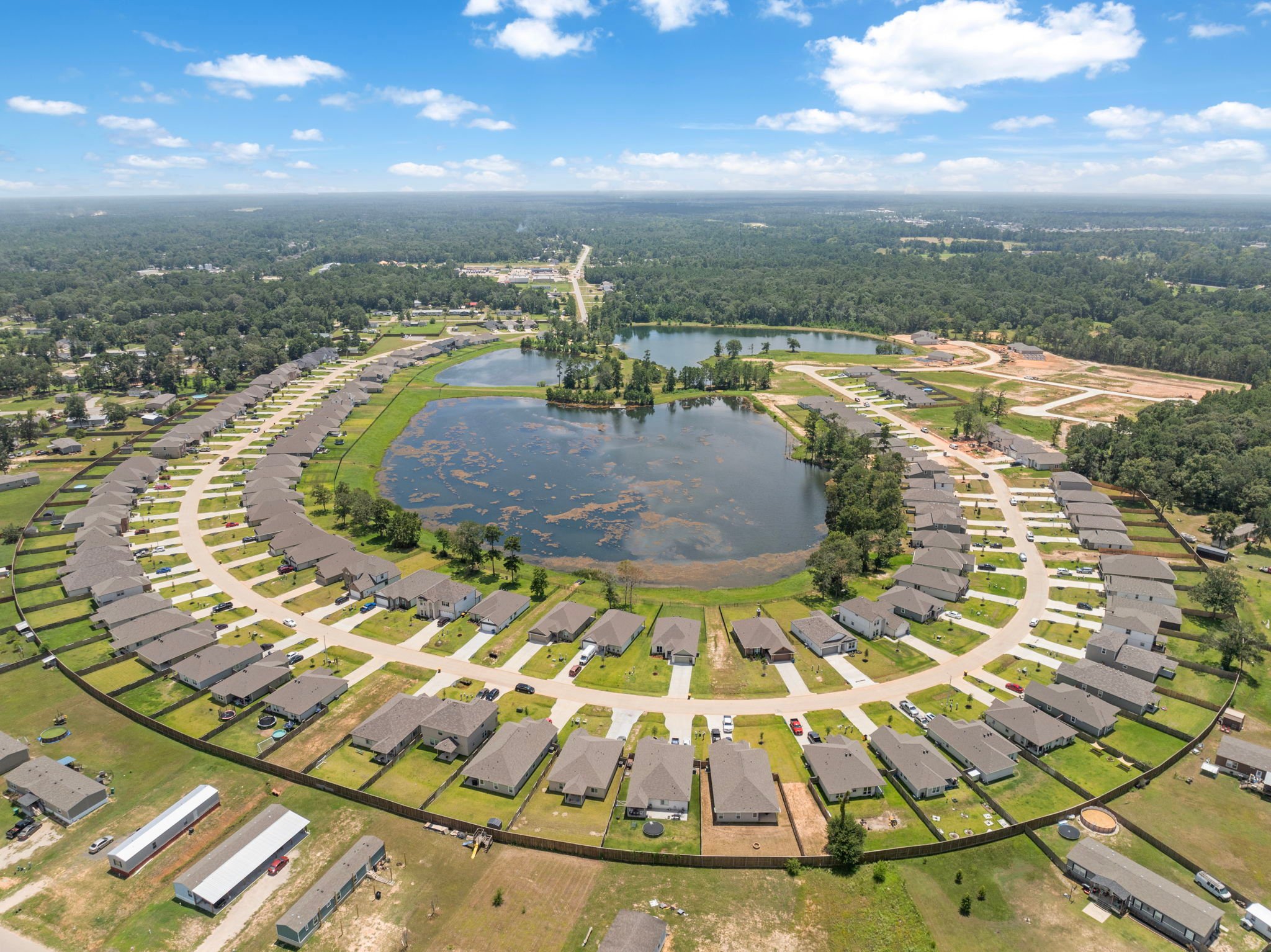 A large area with a pond and buildings around it.