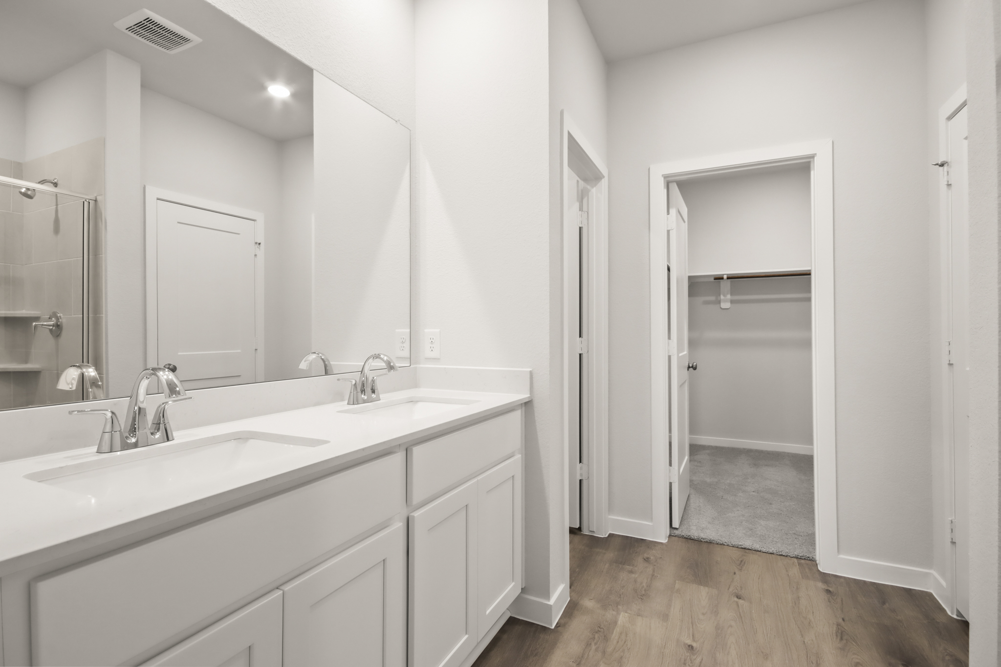 A bathroom with a large mirror.