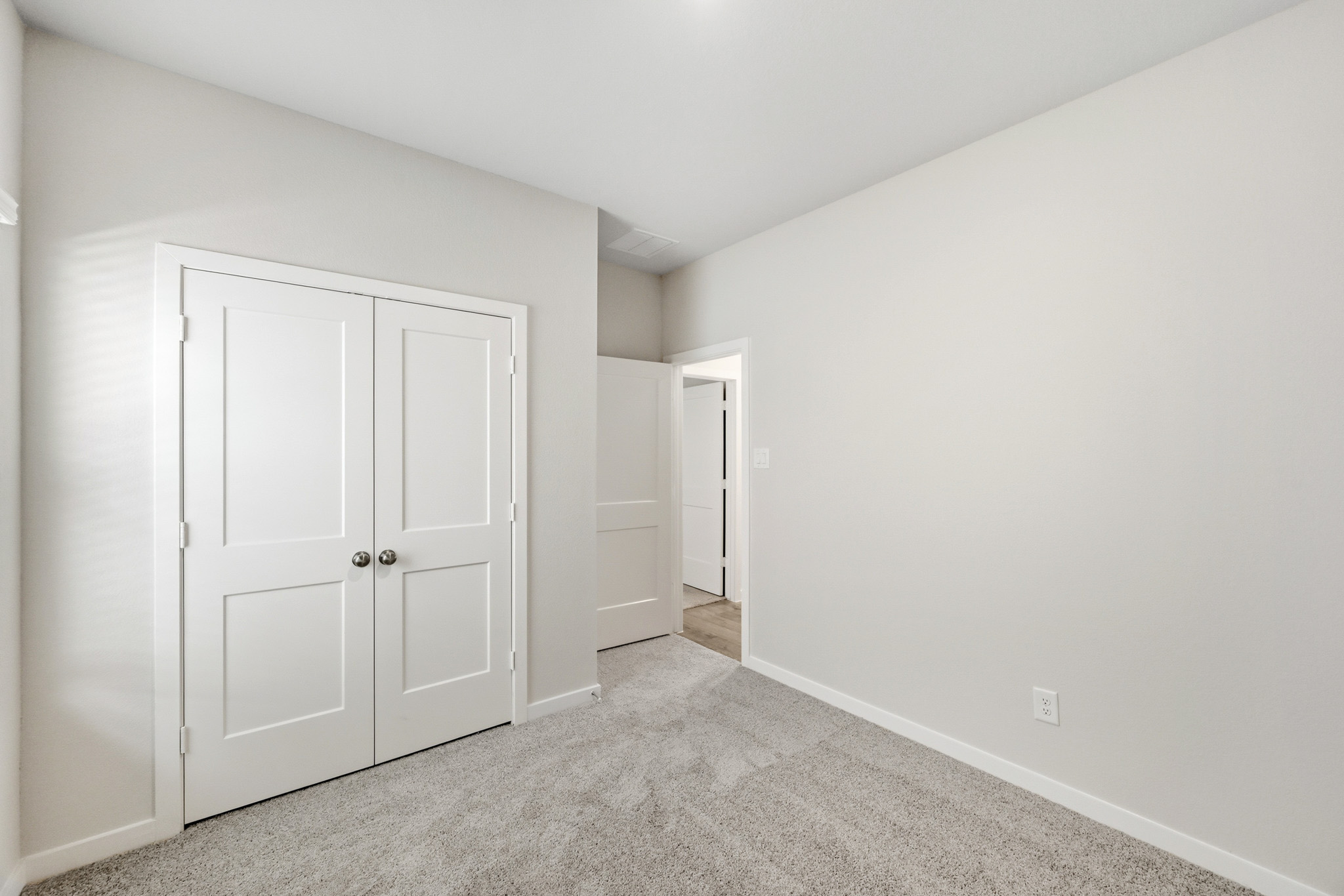 A hallway with white doors.