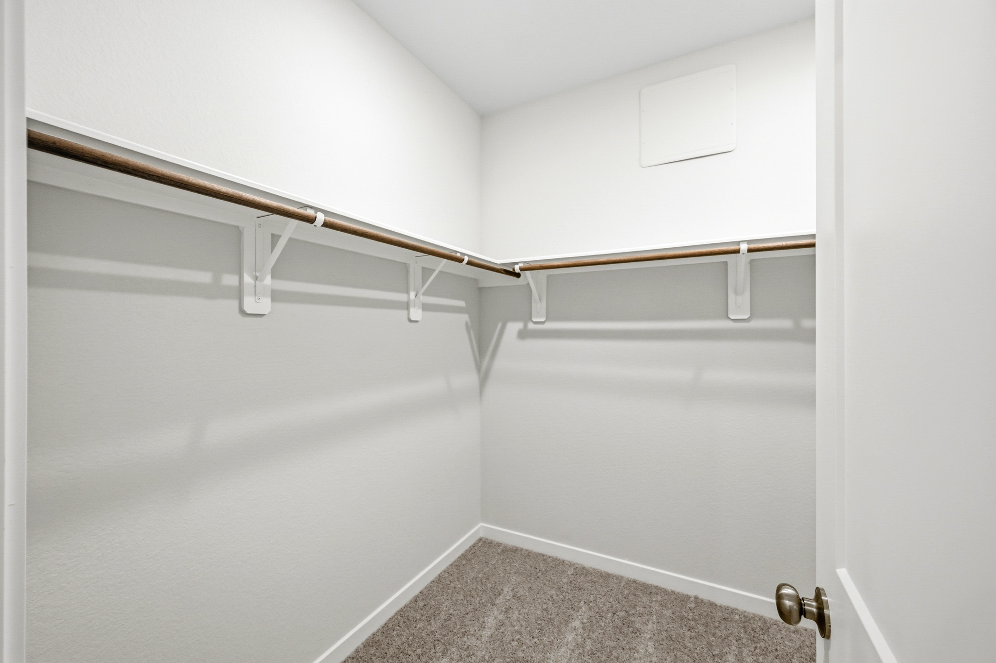 A white wall with a metal railing.