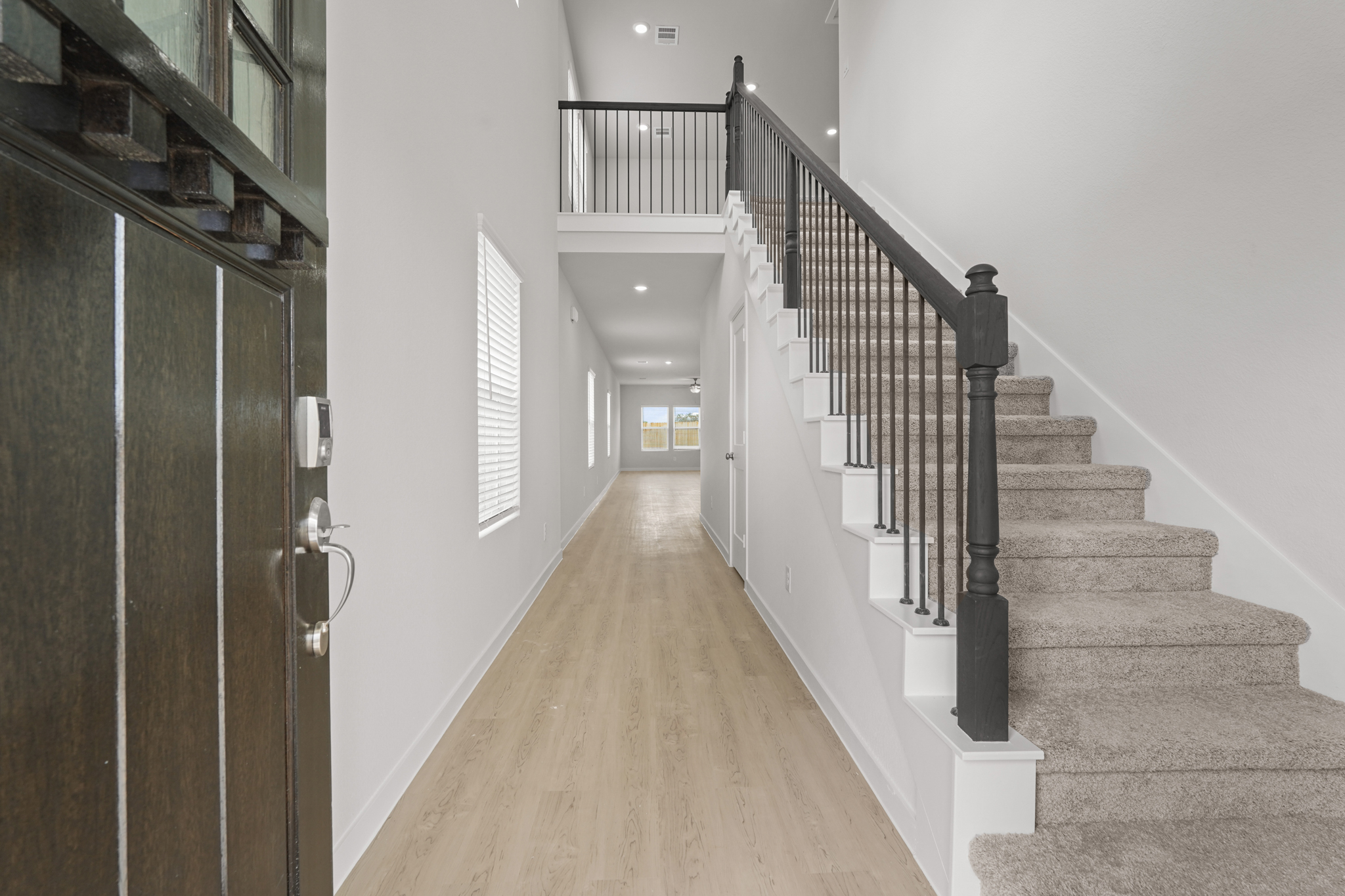 A long hallway with a wood railing.
