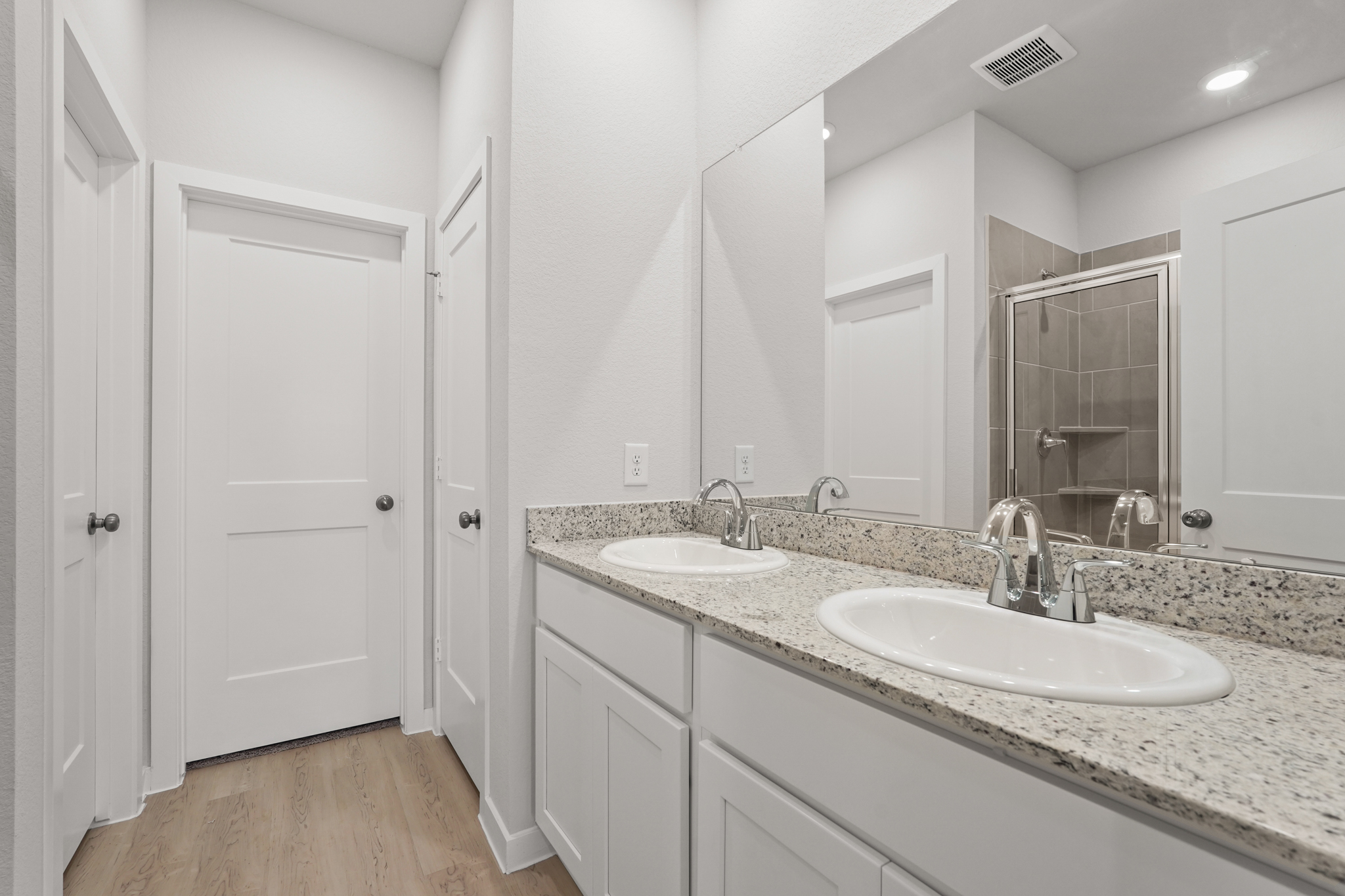 A bathroom with a large mirror.