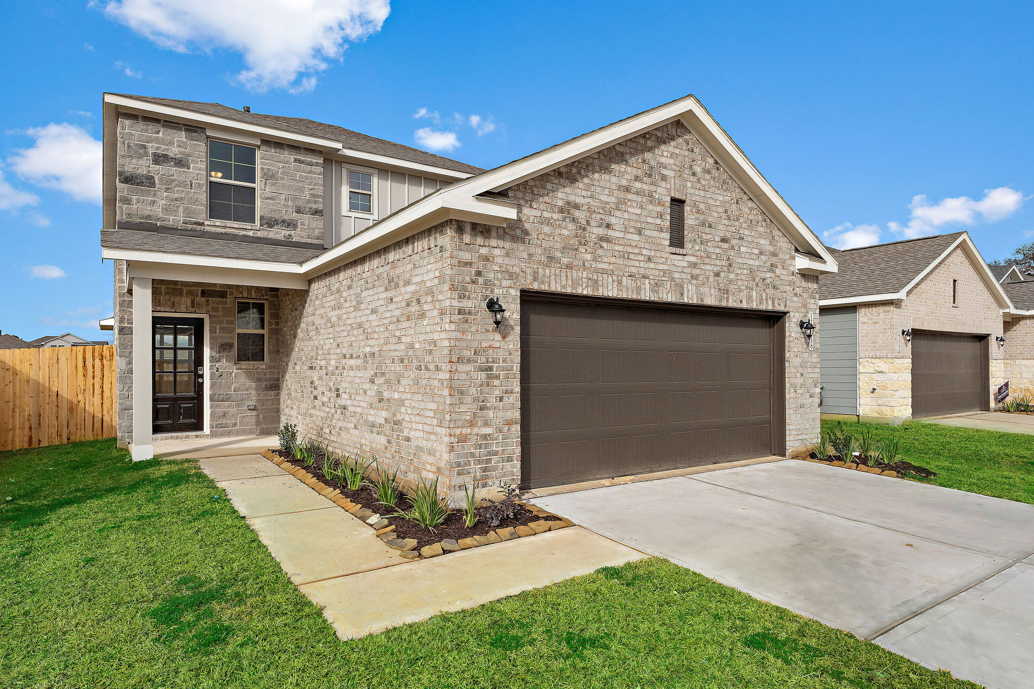A stone house with a garage.