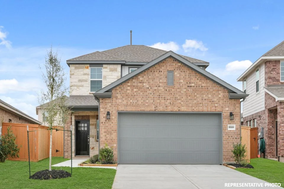 A brick building with a garage.