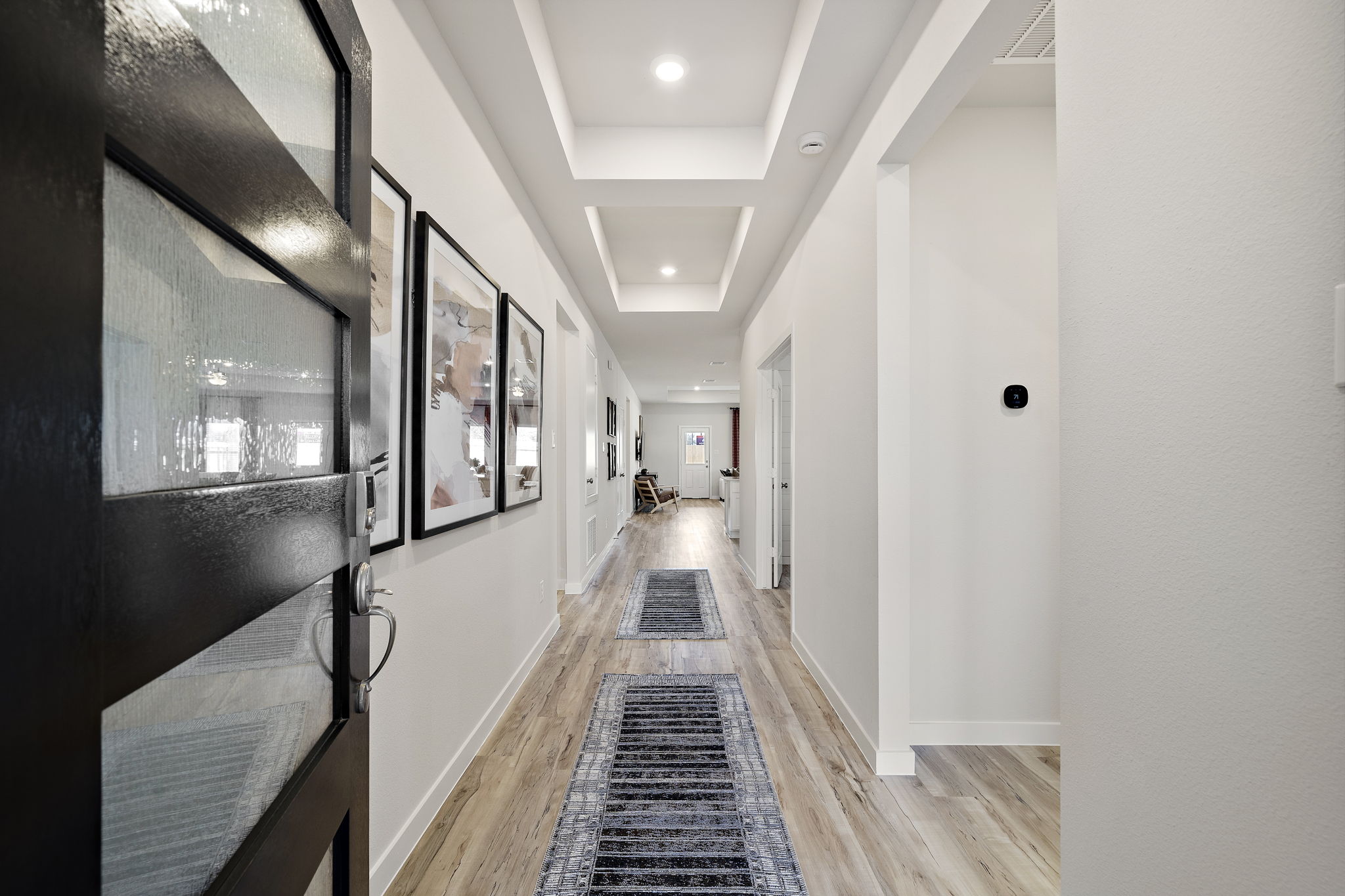 A hallway with white walls.