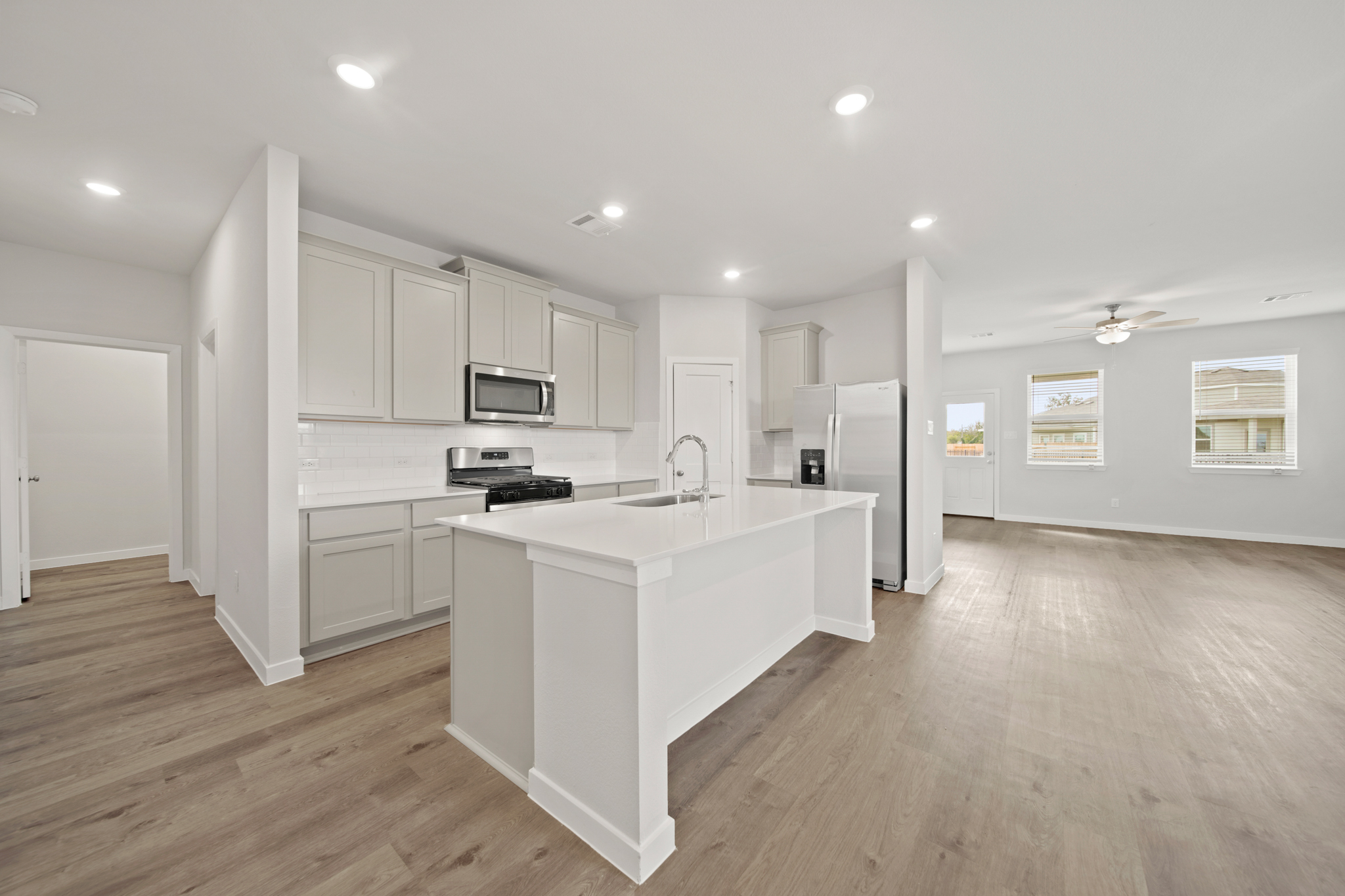 A kitchen with white cabinets.