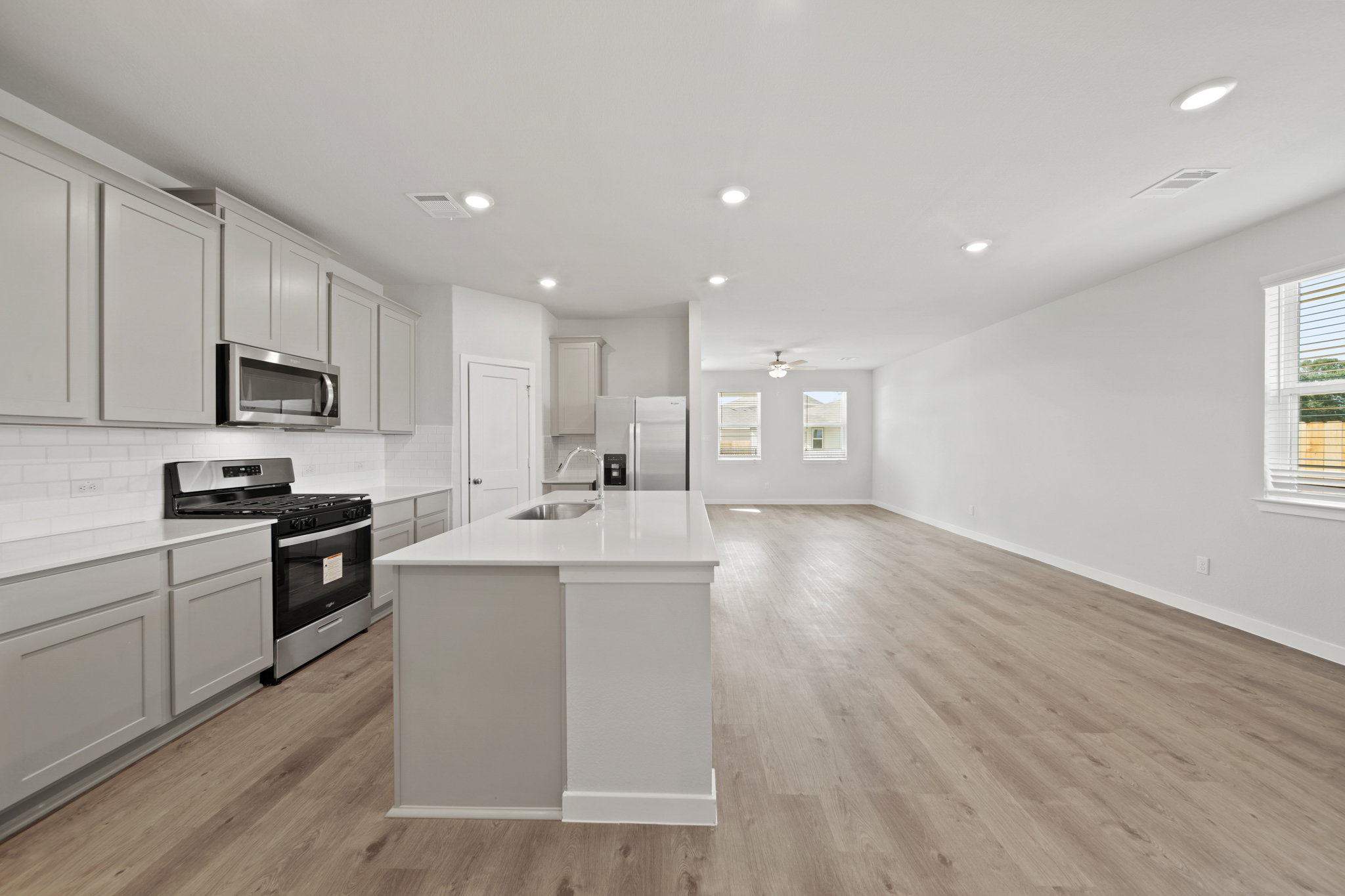 A kitchen with white cabinets.