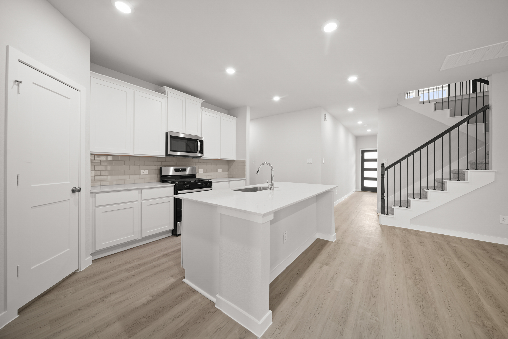 A kitchen with white cabinets.